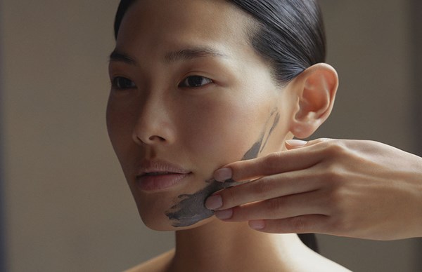 Woman having dark treatment applied to her face during a facial