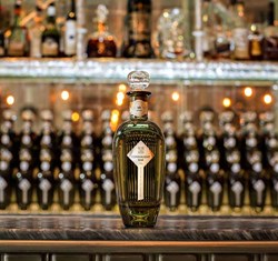 Bottle of gin on marble counter at The Connaught Bar in Mayfair